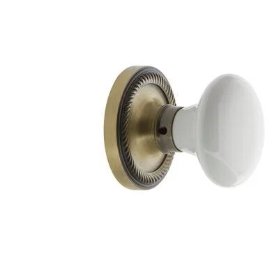 Nostalgic Warehouse 702134 White Porcelain Single Dummy Door Knob with Rope Rosette Finish: Antique Brass